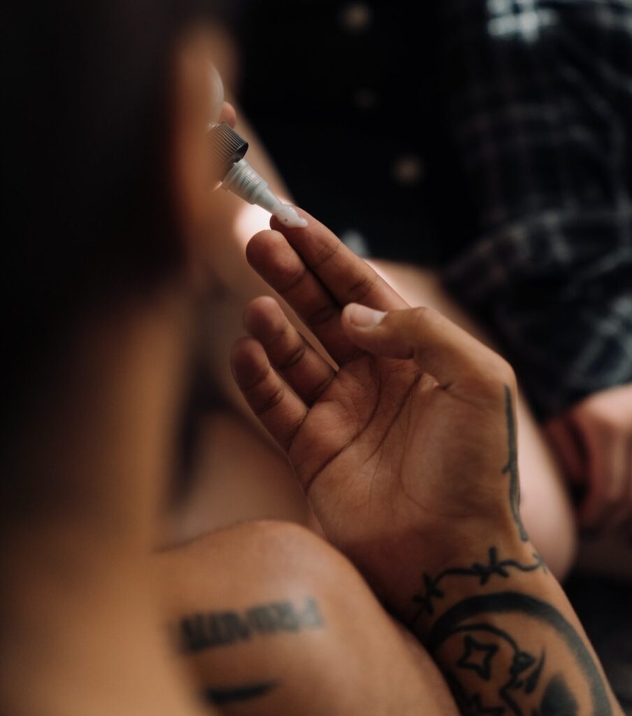 A woman putting vaseline on a tattoo. 
