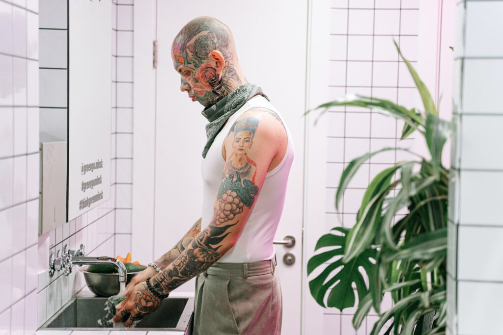 A man routinely washing his new tattoo. 